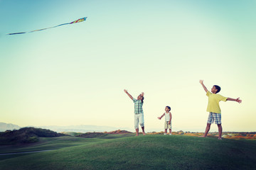 Little boy on summer vacation having fun and happy time flying k