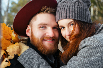 Young couple in love outdoor.Stunning sensual  portrait of  stylish fashion  posing in park in autumn