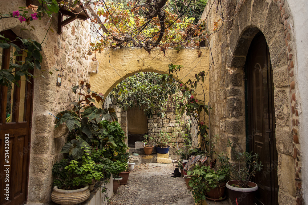Medieval arched backstreet in the old town of Rhodes, Greece - obrazy, fototapety, plakaty 