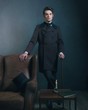 © ysbrandcosijn - Retro dickens style man standing with cane next to leather chair