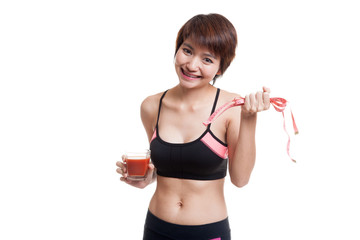 Wall Mural - Healthy Asian girl diet with tomato juice and measuring tape on