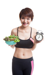 Wall Mural - Beautiful Asian healthy girl with clock and salad.