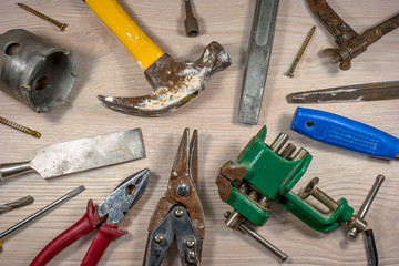 Old tools on wooden background.