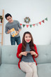 © makistock - Christmas Asian Couple. A handsome man giving her girlfriend/wif
