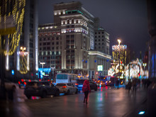 Woman In Red Walks Along The Christmas Decorated Tverskaya Street View Of The Hotel Moscow