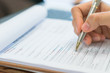 © jannoon028 - Hand with pen over application form .
