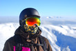 Portrait of a boy in a protective helmet and snowboard mask agai