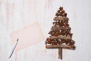 Christmas tree decoration with copy space on white wooden backgr