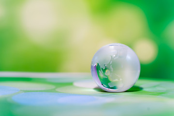 Glass Globe Against Green Background