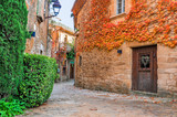 Fototapeta Uliczki - A street in the old town of Peratallada, Catalonia, Spain. Medieval street in the mediaval town in Europe. Panoramic view of old town in beautiful evening light at sunset. 