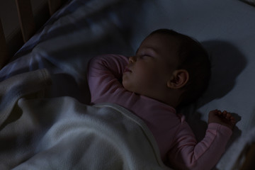 baby sleeping on the bed / adorable baby sleeping at night. little girl in pajama taking a nap in da