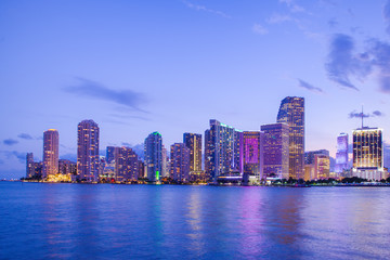 Fototapete - Beautiful Miami Florida skyline with lights and bay at sunset