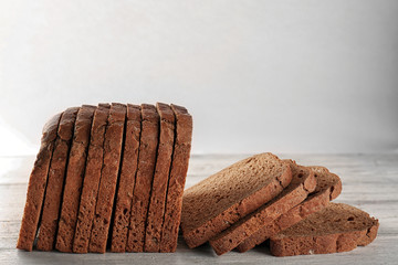 Wall Mural - Sliced rye bread on light background