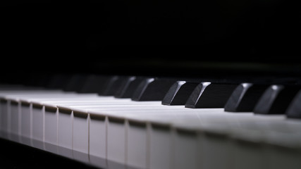 Close up Piano Keys background in low light toned, selective focused