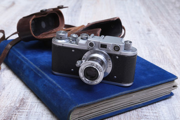 Vintage old film photo-camera in leather case and album