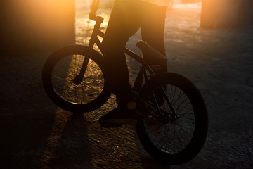 Boy jumping with his bmx in the park. Beautiful background