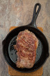 New York strip steak in  a cast iron skillet 