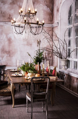 Dining table decorated for Christmas and evergreen centerpiece