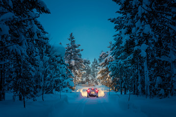 Wall Mural - Winter Driving at night - Lights of car in snowy road