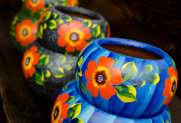 Wall Mural - Stack of Mexican ceramic pots, blue and grey background