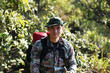 © Sigma s - Man Traveler with backpack trekking in forest, Hikers trekking with backpacks in forest