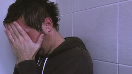 Wall Mural - Depressed unhappy man crying lonely in bathroom