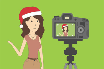 Wall Mural - Christmas blog recording on chroma key background. Vlog. Video recording. Beautiful girl in santa hat.