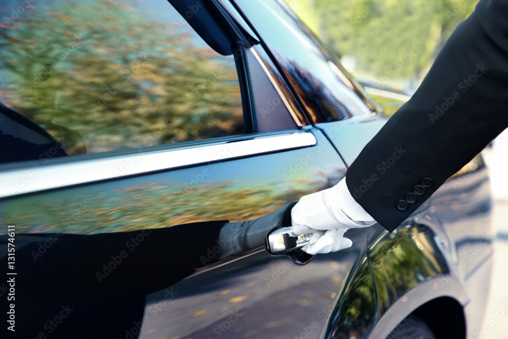 Closeup of chauffeur opening car door