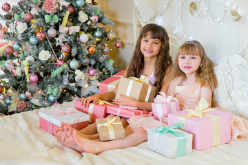 Two adorable girls with Christmas gifts