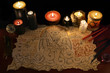 Black magic ritual with demon manuscript and evil candles
