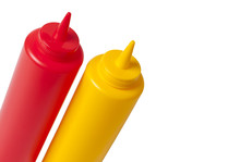 Catsup And Mustard Condiment Bottles In Red And Yellow, Isolated Over White.