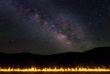Line Of Burning Fire In The Desert With Milky Way