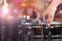 Hand Adjusting Tension Rod Of Snare Drum..Drummer Measuring Batter Tension With Drum Dial And Tuning Tension Rod For A Proper Sound.Copy Space ,multicolour Bokeh Background.