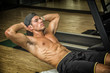 © theartofphoto - Handsome young man doing abs exercises on mat