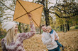 © chika_milan - Dad, mom and son flying a kite in nature