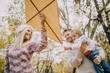 © chika_milan - Dad, mom and son flying a kite in nature