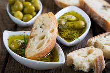 The Bread Dipped In Olive Oil With Herbs And Spices