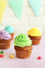 Wall Mural - Fresh tasty cupcakes and birthday decor on blurred background