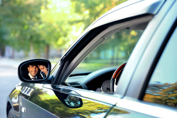 Sticker - Chauffeur driving a car, view from reflection in mirror