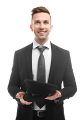 Wall Mural - Young smiling chauffeur holding hat on white background