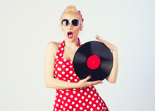 Pin-up Girl In Vintage Dress Holding A Vinyl Record