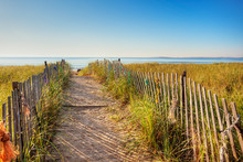 Boardwalk Through The Dunes On The Maine Coast With Colorful Ropes Tied On The Fence