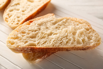 Wall Mural - Sliced fresh bread on wooden cutting board closeup