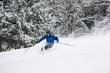 Skiing Teen in Blue Jacket Spraying Powder
