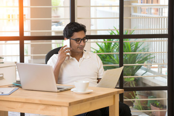 Wall Mural - casual indian male working at office