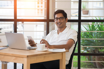 Wall Mural - casual indian male working at office