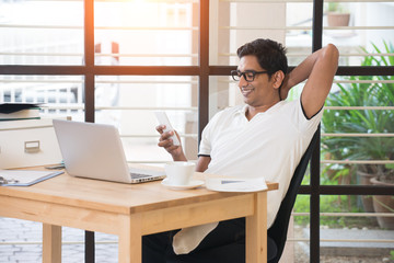 Wall Mural - casual indian male working at office