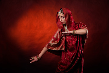 Portrait of beautiful indian girl . Young hindu woman model kundan jewelry . Traditional costume