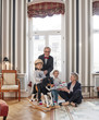 © Westend61 - Grandparents and grandchildren with rocking horse and gift