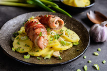 Roasted Chicken Cutlets Wrapped In Bacon And Served With Potato